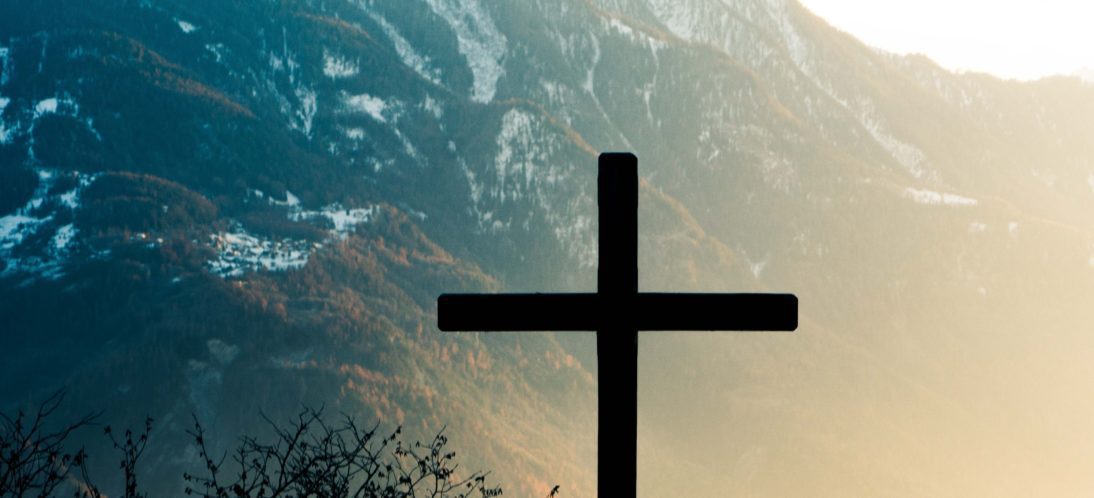Cross in front of His creation.